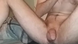 Sitting on the pillow looking at my tablet and stroking big dick! 