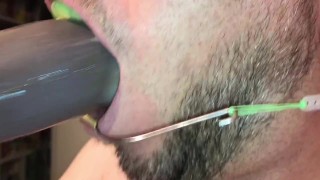 Suck dildo with headgear and mouthguard