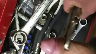 Mechanic plays with his tools