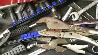 Mechanic plays with his tools