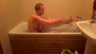 Blonde teen takes a warm bath in the bathtub