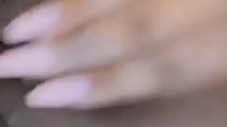Asian girl creaming while fingering herself