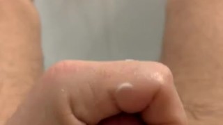 Playing with toy and jerking in bath. 