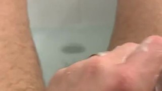 Playing with toy and jerking in bath. 