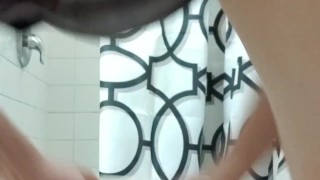 Rear view pissing in toilet