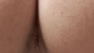 Rear view pissing in toilet
