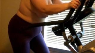 Wife exercising on elliptical topless 