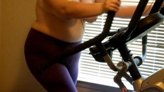 Wife exercising on elliptical topless 