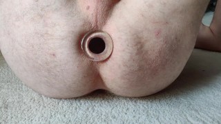 Stretching ass hole by glass butt plug.