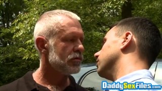 Horny stud fucks mature man in missionary pose in public