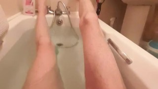 Skinny guy shows off his skinny legs in bathtub and scrubs his cock 