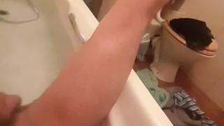 Skinny guy shows off his skinny legs in bathtub and scrubs his cock 