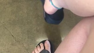 Teasing My mechanic with my stinky feet and dangling flip flop!