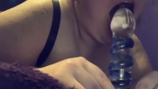 Girl sucking glass dildo with cream
