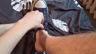 Beautiful legs in sneakers on the bed