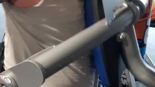 Tattooed muscular guy sweating in the gym 