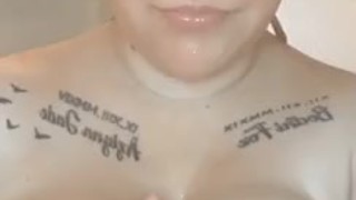 Sexy blonde babe with huge tits, playing with them in hot shower