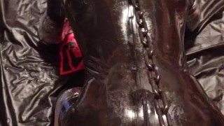 Chained to the bondage post, rubber gimp pup slave getting relentlessly fucked by the fuck machine