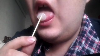 Gay teen licks and eats a lollipop made of his own cum