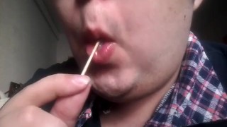 Gay teen licks and eats a lollipop made of his own cum