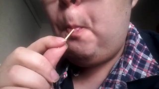 Gay teen licks and eats a lollipop made of his own cum