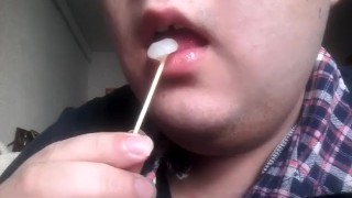 Gay teen licks and eats a lollipop made of his own cum