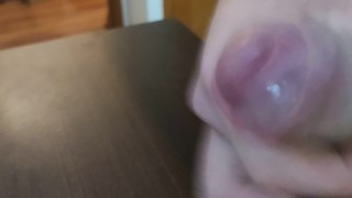 A closeup uncut precum and cumshot
