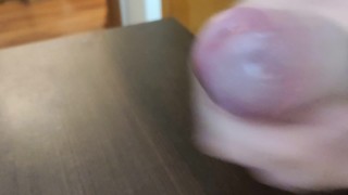 A closeup uncut precum and cumshot