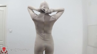 Putting on a leotard over a padlocked zentai