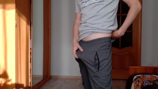 Guy in sweatpants masturbates his big cock and cums on the table