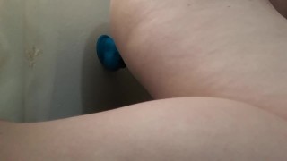Girl masturbates with big blue dildo