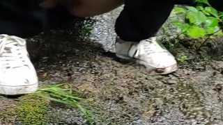 Pissing outside on a rock