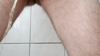 With two hands I roll the head of the penis and piss in the toilet.
