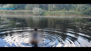 Squatting Nude On The River While Reading