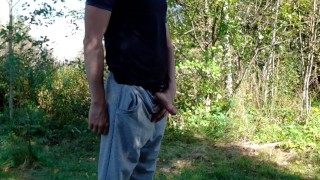 Country boy pissing in a park