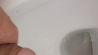 Hot and hung guy filming his dick while jerking off an cum into the toilet sink. 