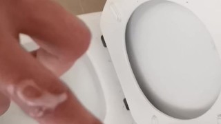 Hot and hung guy filming his dick while jerking off an cum into the toilet sink. 