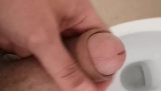 Hot and hung guy filming his dick while jerking off an cum into the toilet sink. 