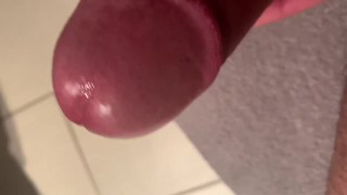 Stroking hard uncut cock and a drop of pre cum