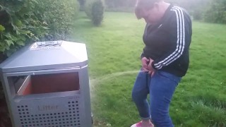 pissing into bin in the park