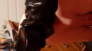 Slave plugged and in chastity, squirming and trying to escape the skintight rubber sleepsack