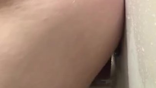 Riding dildo on wall of shower 
