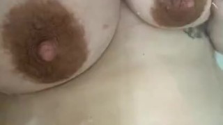 Milkymama hand expresses milk in the bathtub before emerging big tits in water 