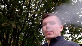 Russian guy smokes a cigarette in dirty shoes and spits