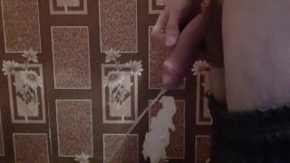 Russian guy with a big dick pees in the toilet