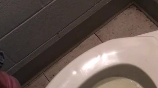 slave peeing in public toilet