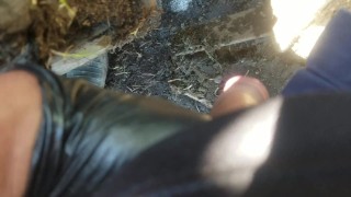 Pov lad unzips and flops it out to take a yellow piss next to muddy tire