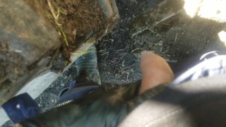 Pov lad unzips and flops it out to take a yellow piss next to muddy tire