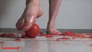 Several tomatoes are crushed under my wonderful bare feet