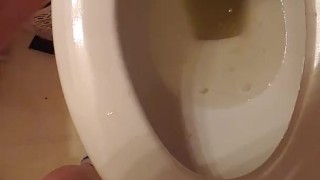 Golden stream. Peeing in toilet. Up close
